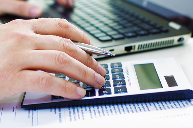 Business man in dark suit whit calculator Detail of Business man in dark suit whit calculator